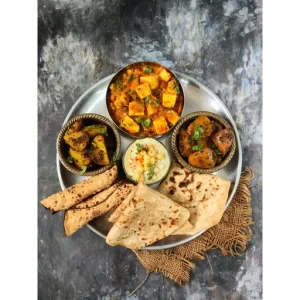 Matar Paneer, Aloo Gutke, Kaddu Ki Sabzi, Boondi Raita, Papad, Paratha